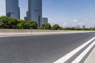 Panoramik siluet ve boş yolu, boş beton zemini olan modern iş binaları.