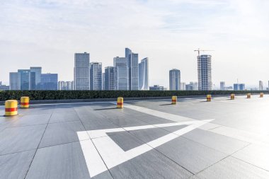 Panoramik siluet ve boş yolu, boş beton zemini olan modern iş binaları.