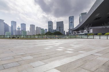 Panoramik siluet ve boş yolu, boş beton zemini olan modern iş binaları.
