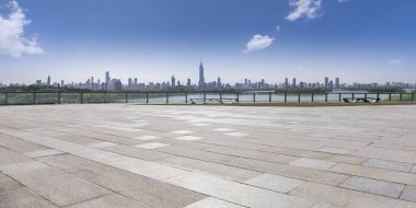 Panoramik siluet ve boş yolu, boş beton zemini olan modern iş binaları.