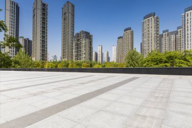 Panoramik siluet ve boş yolu, boş beton zemini olan modern iş binaları.