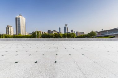 Panoramik siluet ve boş yolu, boş beton zemini olan modern iş binaları.