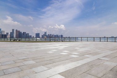 Panoramik siluet ve boş yolu, boş beton zemini olan modern iş binaları.