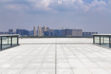 Panoramik siluet ve boş yolu, boş beton zemini olan modern iş binaları.