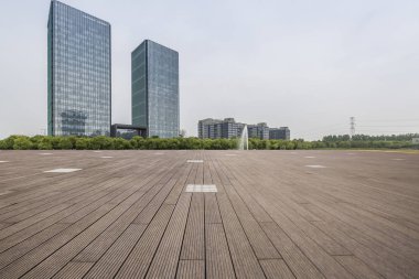 Panoramik siluet ve boş yolu, boş beton zemini olan modern iş binaları.