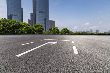 Panoramik siluet ve boş yolu, boş beton zemini olan modern iş binaları.