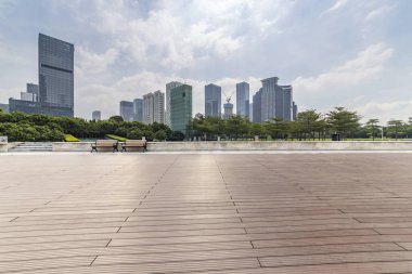 Panoramik siluet ve boş yolu, boş beton zemini olan modern iş binaları.