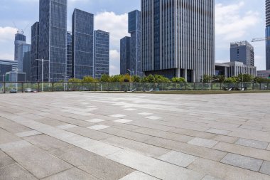 Panoramik siluet ve boş yolu, boş beton zemini olan modern iş binaları.