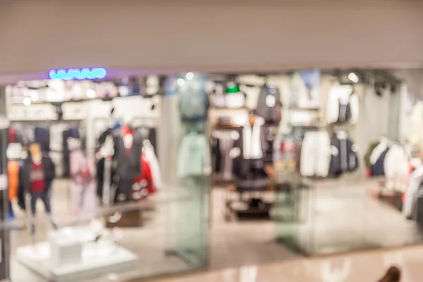 Abstract blur boutique fashion display window with mannequins in shopping mall