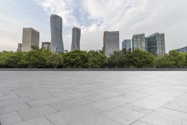 Panoramik siluet ve boş yolu, boş beton zemini olan modern iş binaları.