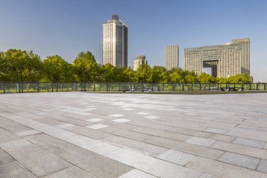 Panoramik siluet ve boş yolu, boş beton zemini olan modern iş binaları.