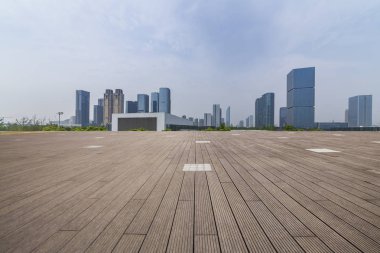 Panoramik siluet ve boş yolu, boş beton zemini olan modern iş binaları.