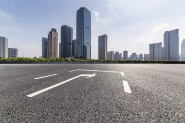 Panoramik siluet ve boş yolu, boş beton zemini olan modern iş binaları.