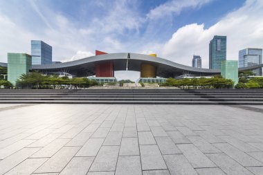 Panoramik siluet ve boş yolu, boş beton zemini olan modern iş binaları.