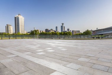 Panoramik siluet ve boş yolu, boş beton zemini olan modern iş binaları.