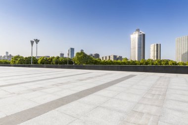 Panoramik siluet ve boş yolu, boş beton zemini olan modern iş binaları.