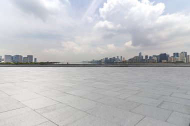 Panoramik siluet ve boş yolu, boş beton zemini olan modern iş binaları.