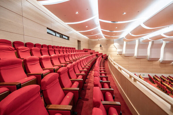 Rows of red seats inside a cinema hall
