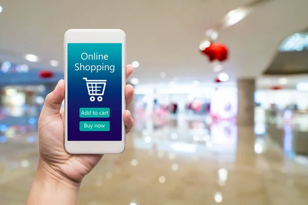 Telefone inteligente compras on-line na mão da mulher. Centro comercial em ba — Fotografia de Stock