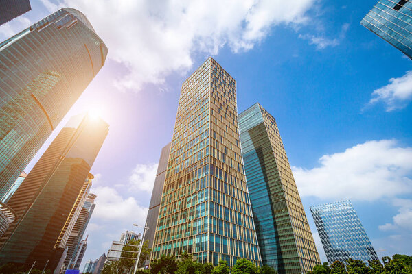 Bottom view of modern skyscrapers in business district against b