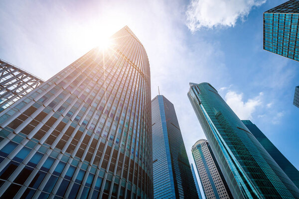 Bottom view of modern skyscrapers in business district against b