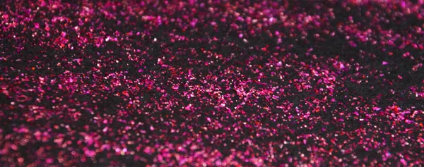 dark pink shiny glitter on black background.