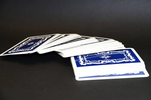 unfolded deck of tarot cards on black background lose up