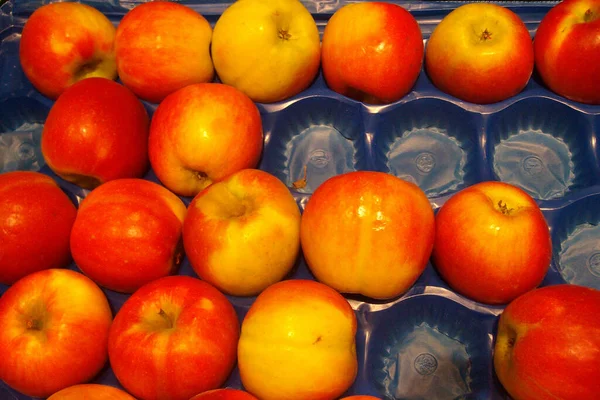 red apples in a tray in a store close up