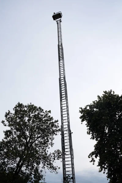 retractable fire stairs on the background of trees and sky