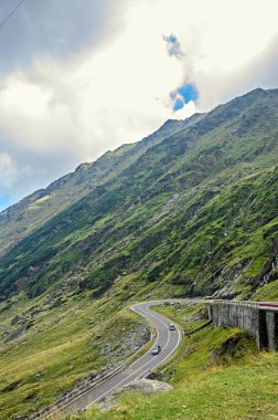 Transfagarasan yolun Fagaras Dağları, yeşil çim ve kayalar, Karpatlar bulutlarda doruklarına.