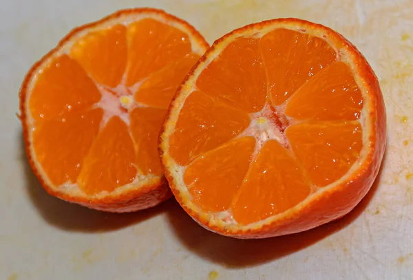 Half orange jucy fruit, close up, white background.