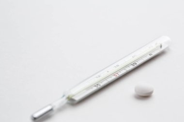Eski bir cıva termometre beyaz izole arka planda ilaçlarla. Üstten Görünüm