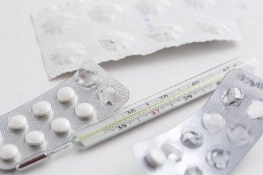 Eski bir cıva termometre beyaz izole arka planda ilaçlarla. Üstten Görünüm