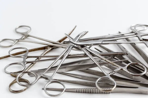 Vintage medical instruments, scalpel, scissors, clips and tweezers on white isolated background