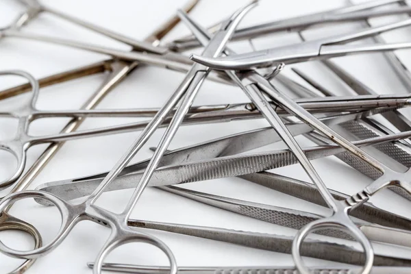 Vintage medical instruments, scalpel, scissors, clips and tweezers on white isolated background