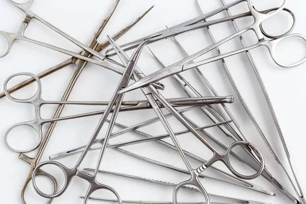 Vintage medical instruments, scalpel, scissors, clips and tweezers on white isolated background
