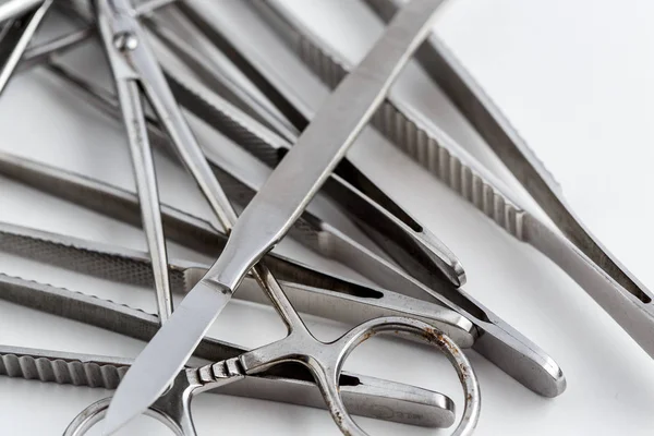 Vintage medical instruments, scalpel, scissors, clips and tweezers on white isolated background