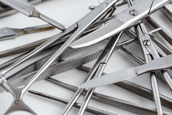 Vintage medical instruments, scalpel, scissors, clips and tweezers on white isolated background