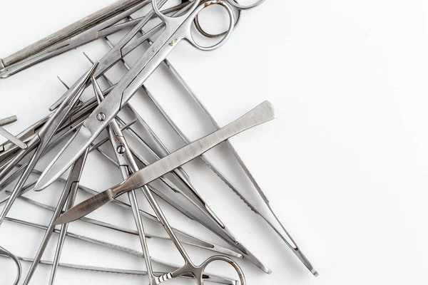 Vintage medical instruments, scalpel, scissors, clips and tweezers on white isolated background