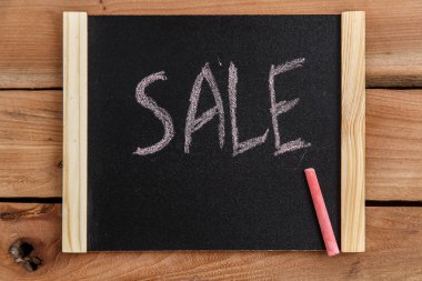 Bir ahşap çerçeve yazıt Satılık ahşap bir zemin üzerine siyah yönetim kurulu