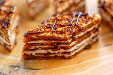 Dilim kek katmanları ahşap bir masa üzerinde tuval üzerine krema ile