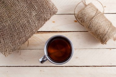 Sıcak içecek ahşap arka plan üzerinde vintage bir kupa. Yukarıdan görüntülemek.