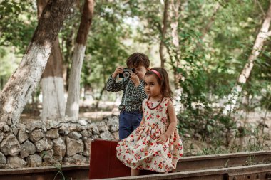Vintage tarzı fotoğraf çekimi. Erkek ve kız vintage giyim vintage aksesuarları terk edilmiş tren ve tren istasyonu ile