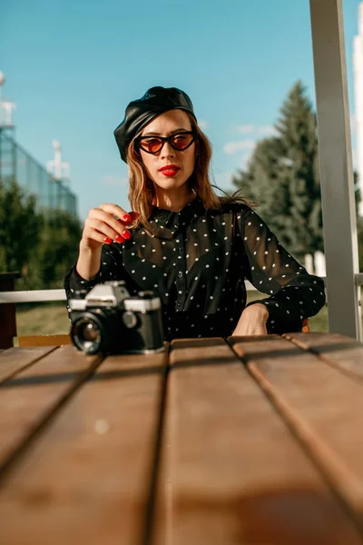 Young beautiful woman in a vintage polka-dot dress in a retro-style photo shoot