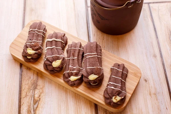 shortbread cookies on a wooden stand on a wooden background with tea . the view from the top