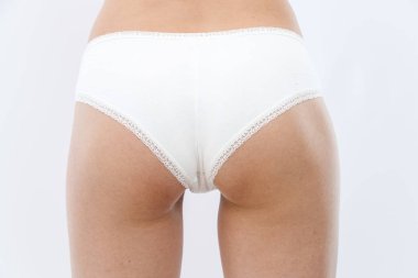 arka görünüm. beyaz iç çamaşırı ince genç atletik kız onu gösterir 