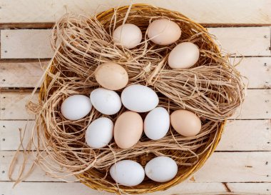 ahşap bir arka plan üzerinde saman çiğ yumurta