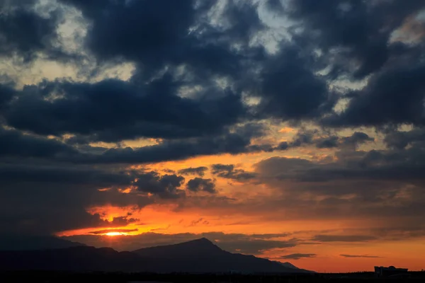 The sun sets behind the mountains. beautiful panorama and view o — Stock Photo, Image