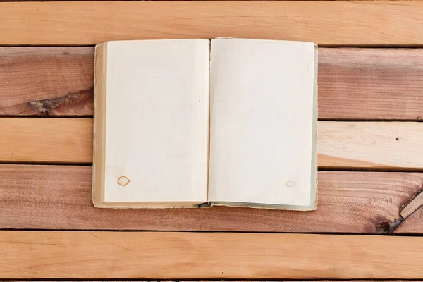 sheets of book with empty space on wooden background