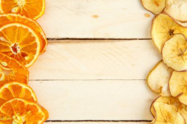 Ahşap arka planda kurumuş elma ve portakallar. en üstteki görünüm